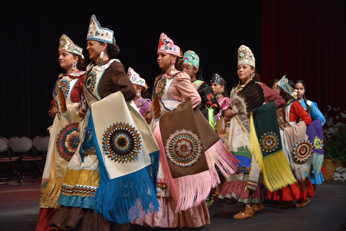 Image of the dancers walking on the stage. 